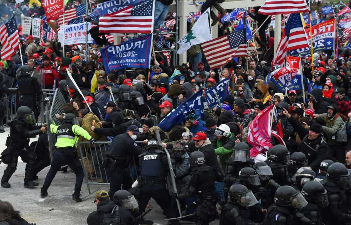Rioters clash with police as they push barricades to storm the US Capitol in Washington on January 6, 2021 Rioters clash with police as they push barricades to storm the US Capitol in Washington on January 6, 2021