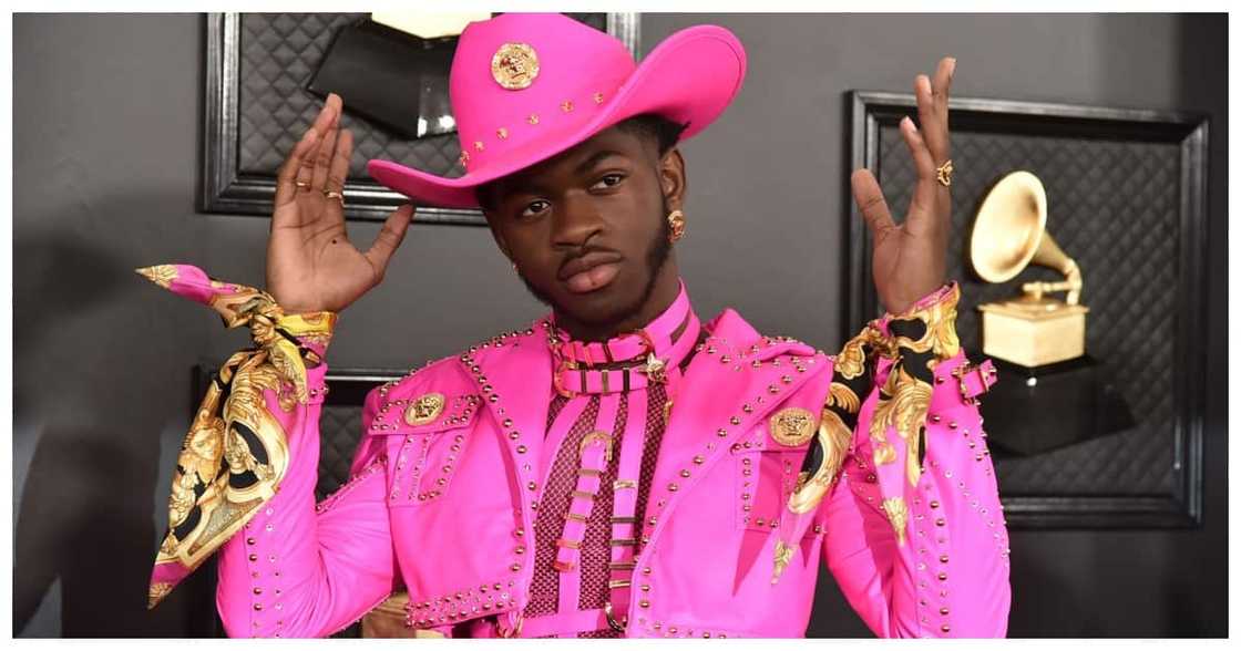 Lil Nas shows up in a unique purple outfit at VMAs red carpet event. Lil Nas shows up in a unique purple outfit at VMAs red carpet event.