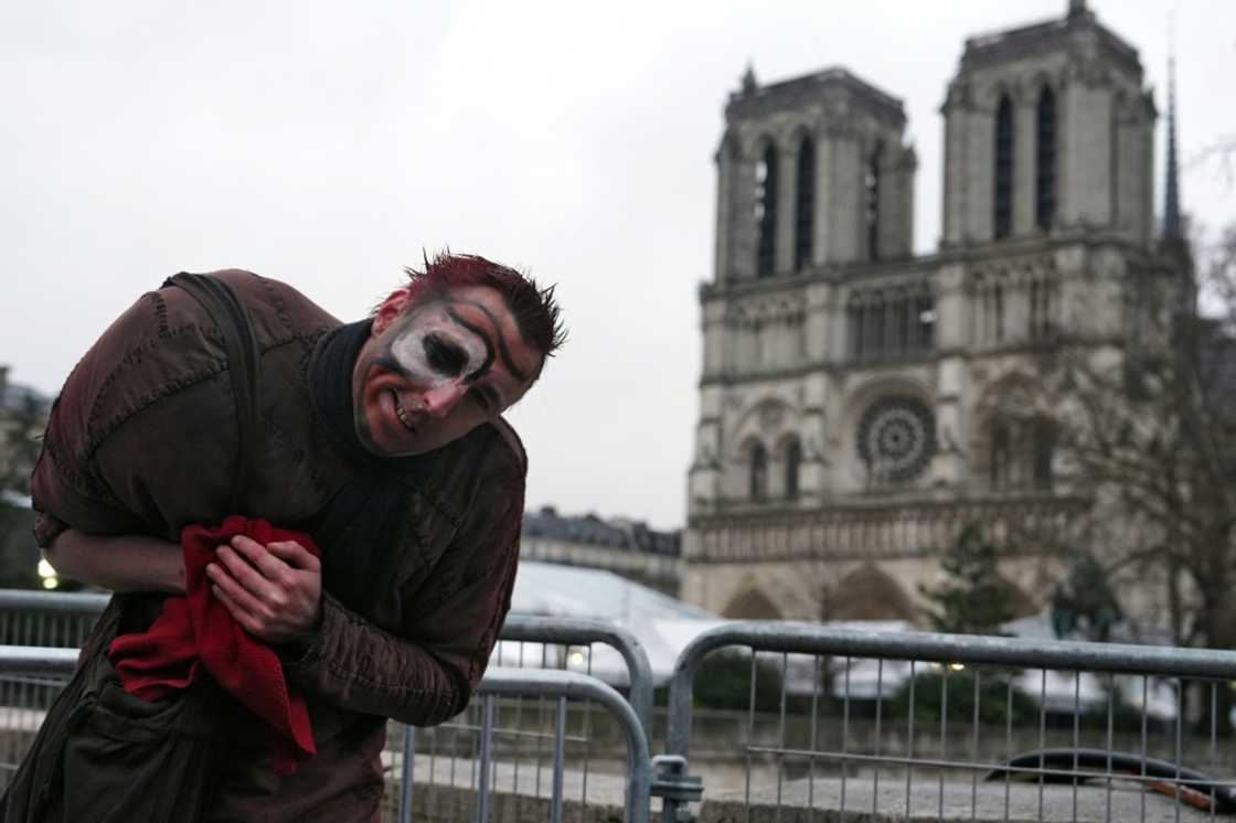 A man dressed as Quasimodo performs for tourists near Notre Dame Cathedral in central Paris A man dressed as Quasimodo performs for tourists near Notre Dame Cathedral in central Paris