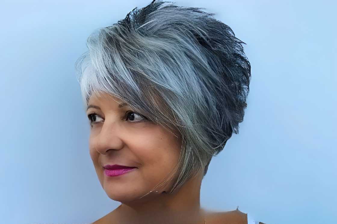 A woman rocks a pixie haircut with side swept bang A woman rocks a pixie haircut with side swept bang