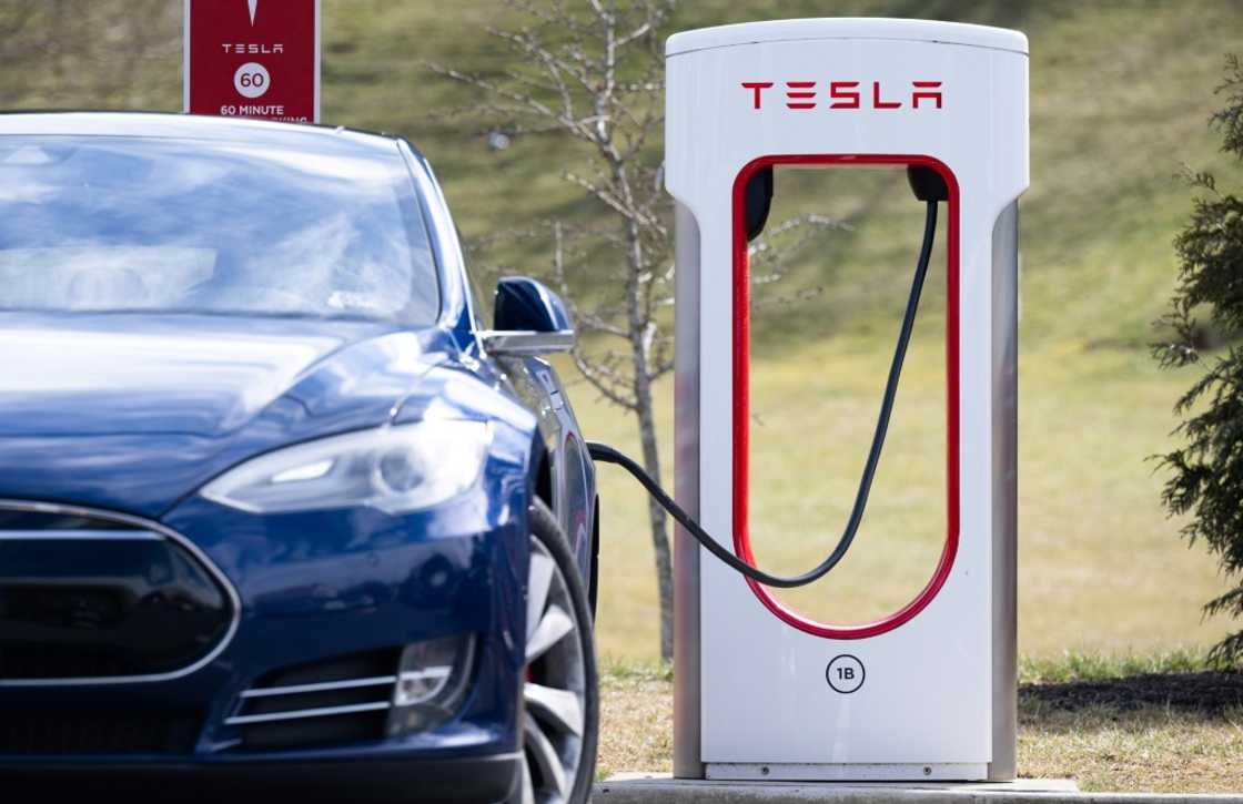 A Tesla Model S sedan is plugged into a charging station in Falls Church, Virginia