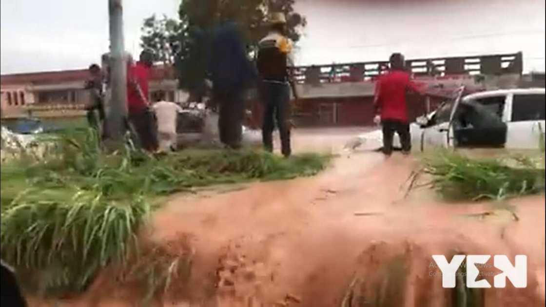 Two boys in Kumasi save taxi Driver from Drowning as Water Taking him Away in Chilling Video Two boys in Kumasi save taxi Driver from Drowning as Water Taking him Away in Chilling Video