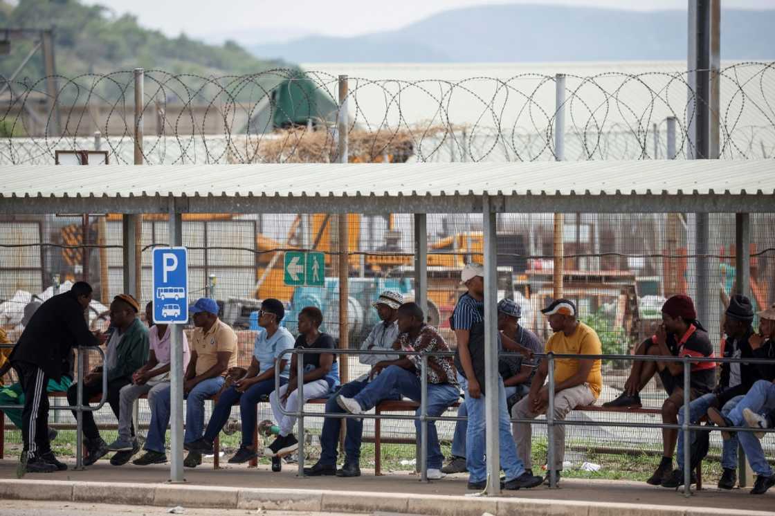 Workers wait at the surface for news of more than 2,000 miners occupying the Impala Bafokeng platinum mine since Monday Workers wait at the surface for news of more than 2,000 miners occupying the Impala Bafokeng platinum mine since Monday