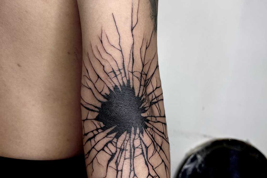 Blackwork jagged hole elbow tattoo Blackwork jagged hole elbow tattoo