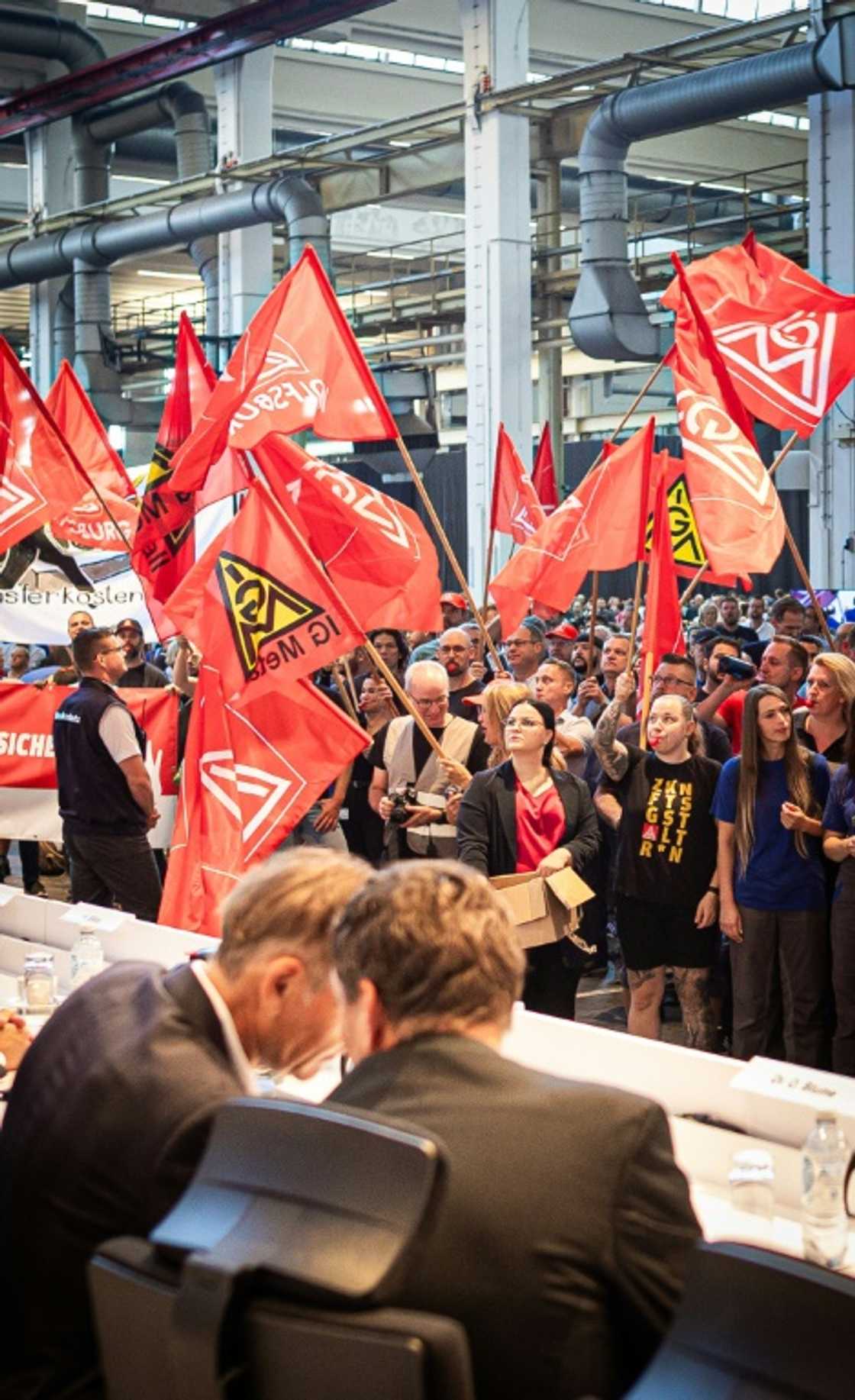 Workers at German carmaker Volkswagen (VW) protest at the start of a company general meeting