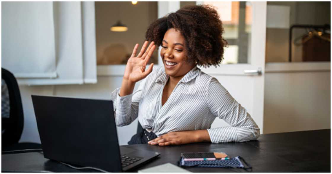 A woman smiles as the number of followers for her business increases