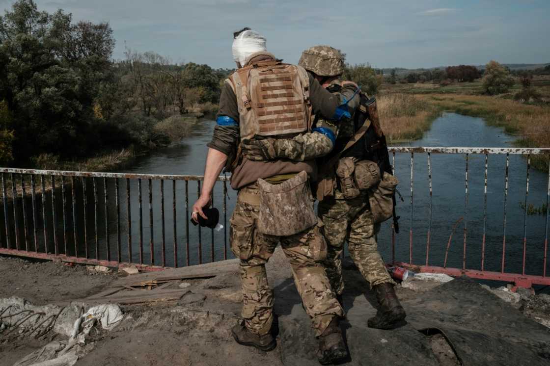 A wounded Ukrainian serviceman crosses a bridge in a recently retaken area near Kharkiv A wounded Ukrainian serviceman crosses a bridge in a recently retaken area near Kharkiv
