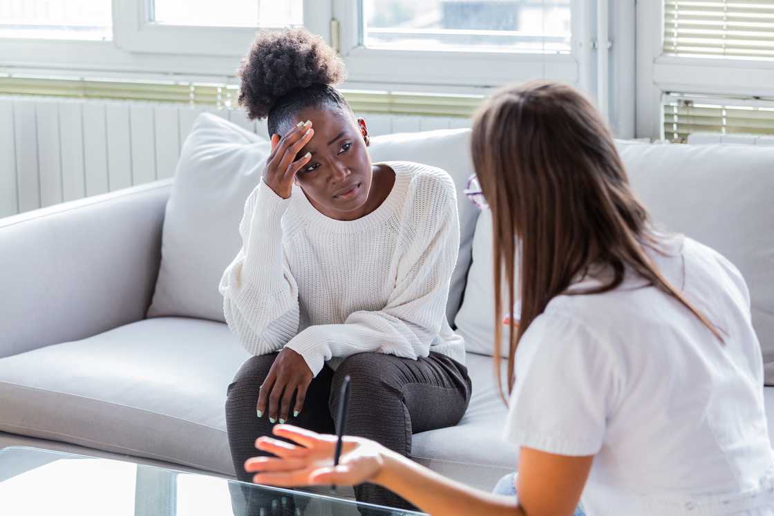 A woman speaks with a therapist at the counseling office. A woman speaks with a therapist at the counseling office.