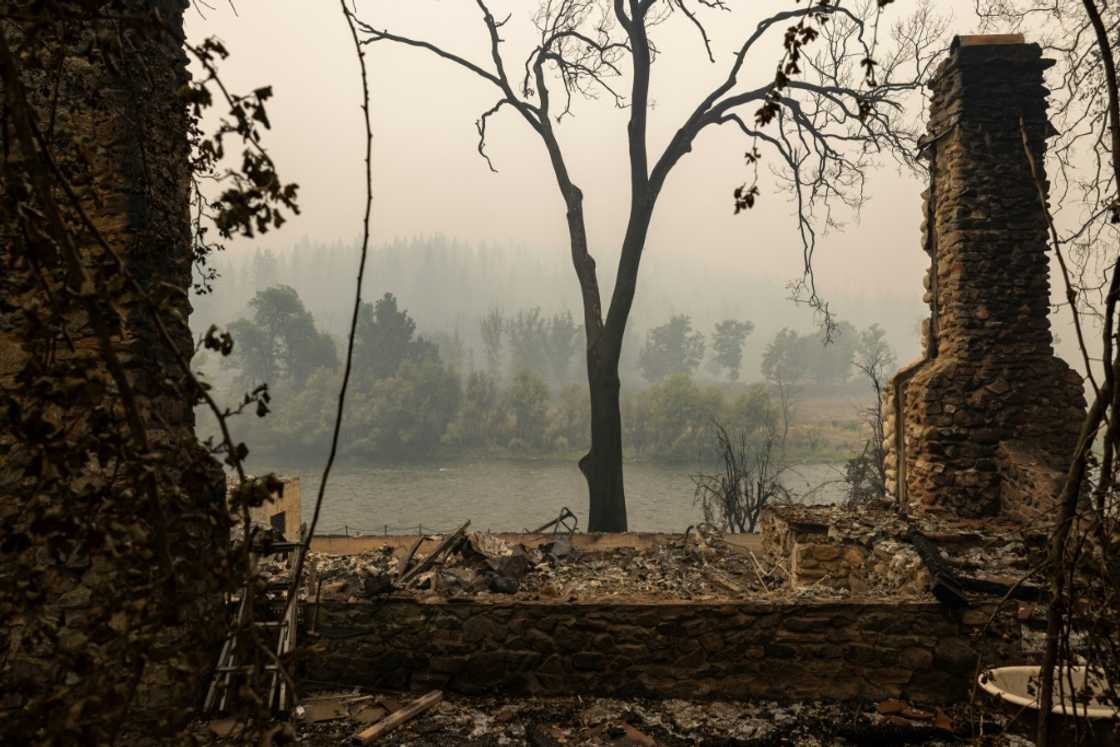 A chimney is all that remains of a river-front home in Klamath River northwest of Yreka, California A chimney is all that remains of a river-front home in Klamath River northwest of Yreka, California