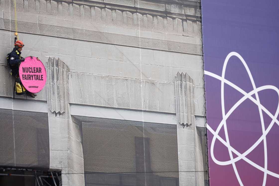 A Greenpeace activist at the nuclear summit venue with a banner reading 'Nuclear Fairy Tale' A Greenpeace activist at the nuclear summit venue with a banner reading 'Nuclear Fairy Tale'