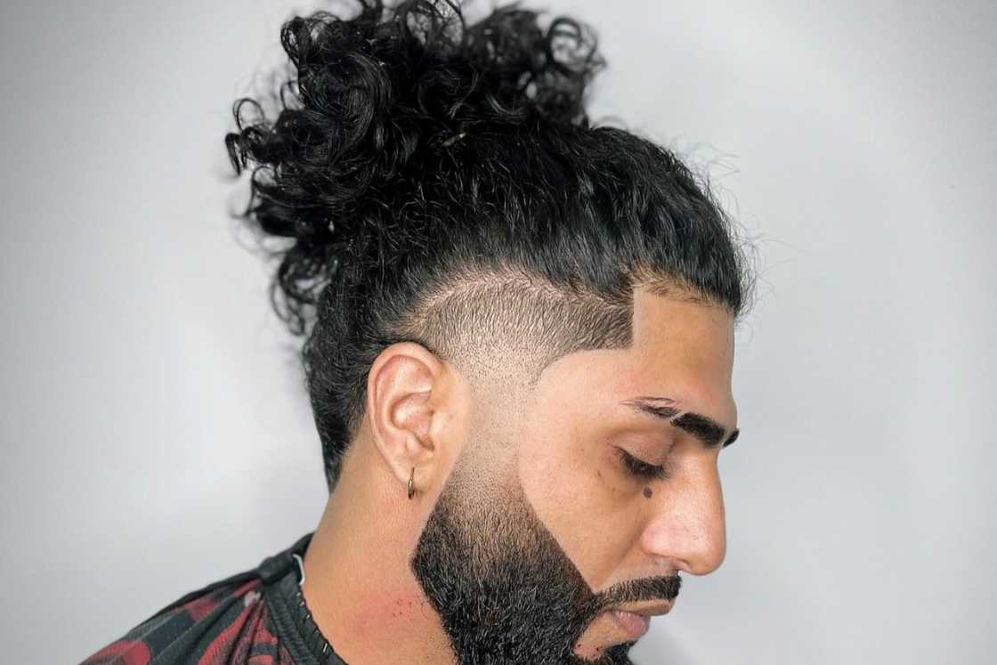 A man at barbershop for a long hair with a fade hairstyle A man at barbershop for a long hair with a fade hairstyle