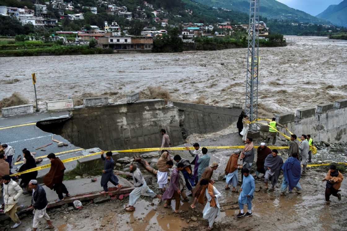 A swollen river in Swat in Pakistan's north destroyed a road running along its banks A swollen river in Swat in Pakistan's north destroyed a road running along its banks
