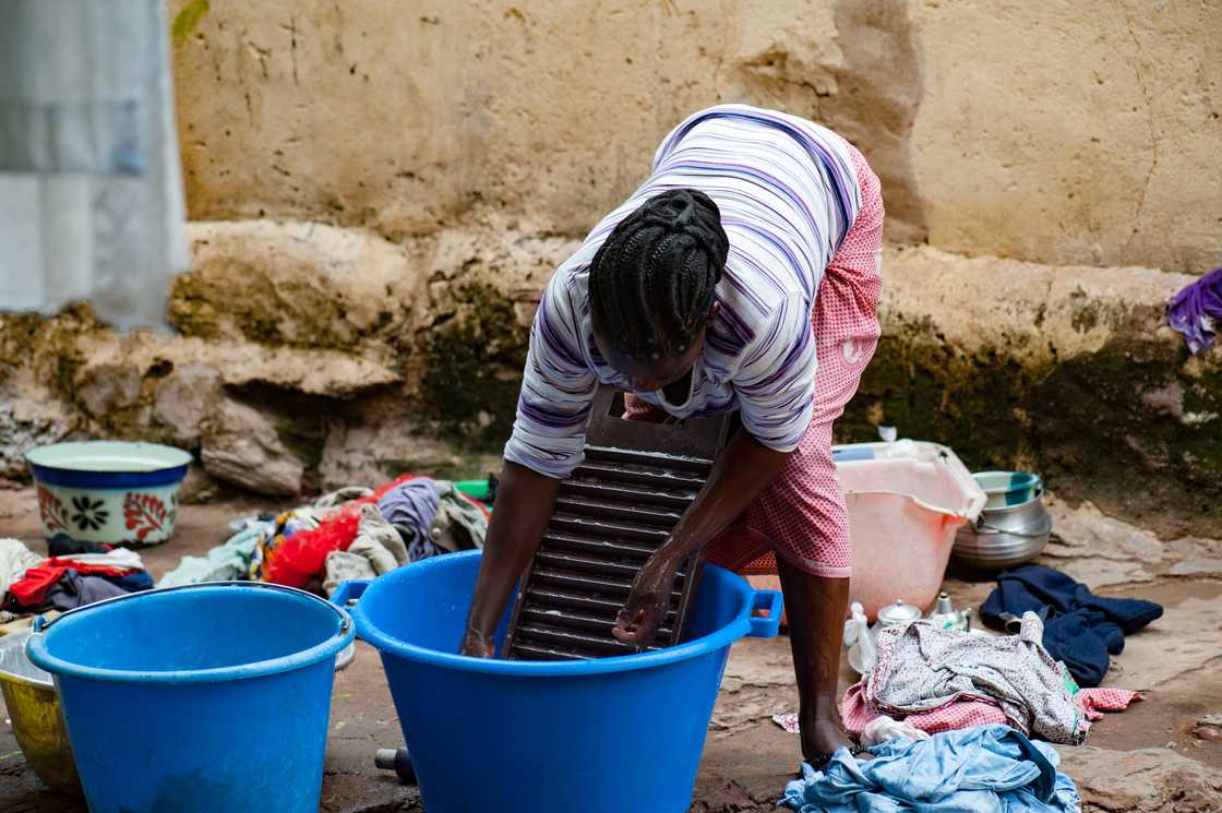A lady hand washing clothes A lady hand washing clothes