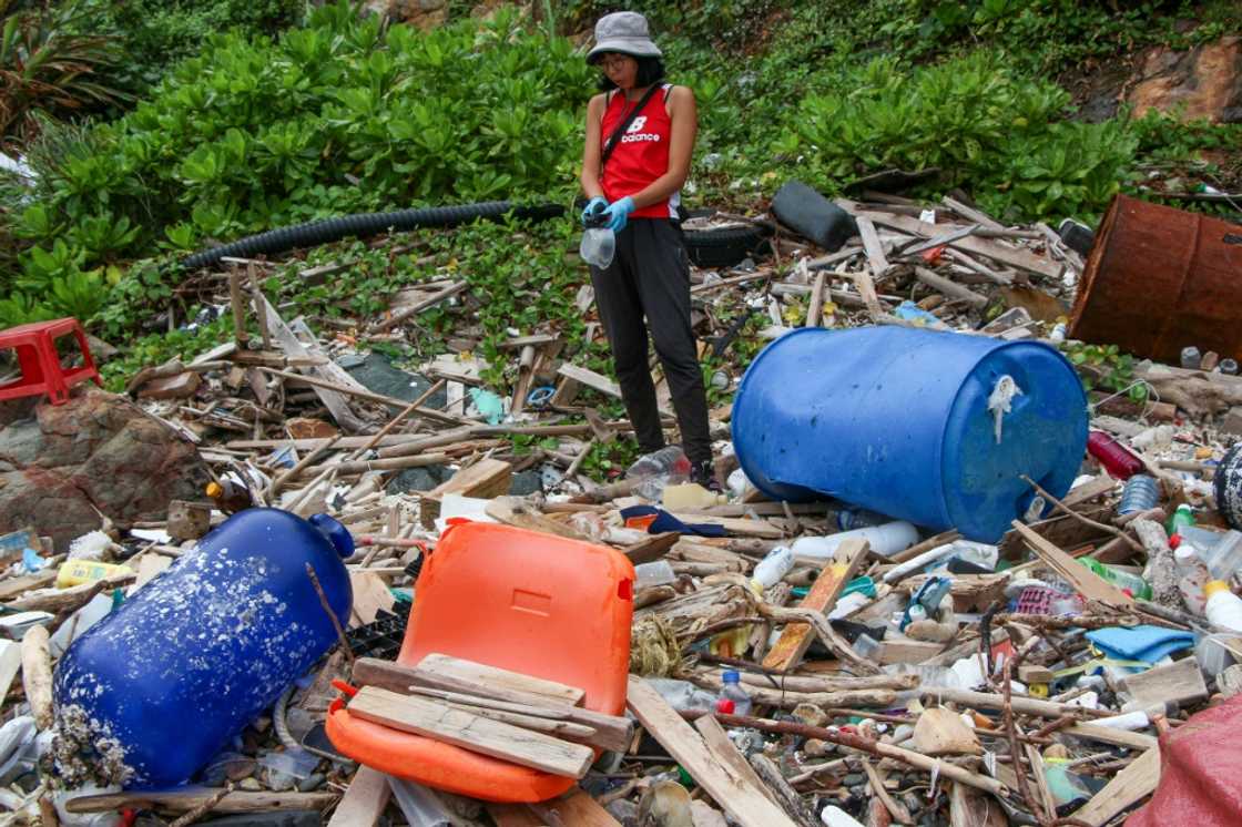 Environmental educator Yeungs Ting collects plastic waste at a beach cleaning in Hong Kong