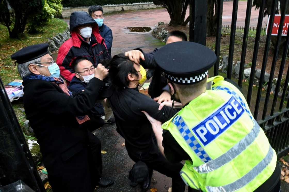 British police have said a group of men came out of China's Manchester consulate and dragged one of the protesters inside British police have said a group of men came out of China's Manchester consulate and dragged one of the protesters inside