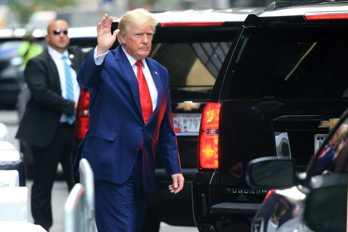 Former US president Donald Trump waves before attending a deposition in a New York civil case Former US president Donald Trump waves before attending a deposition in a New York civil case