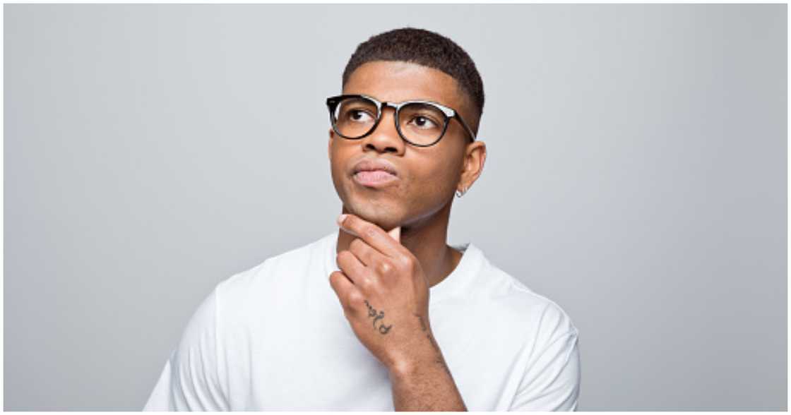 A man looks confused about a decision he has to take A man looks confused about a decision he has to take