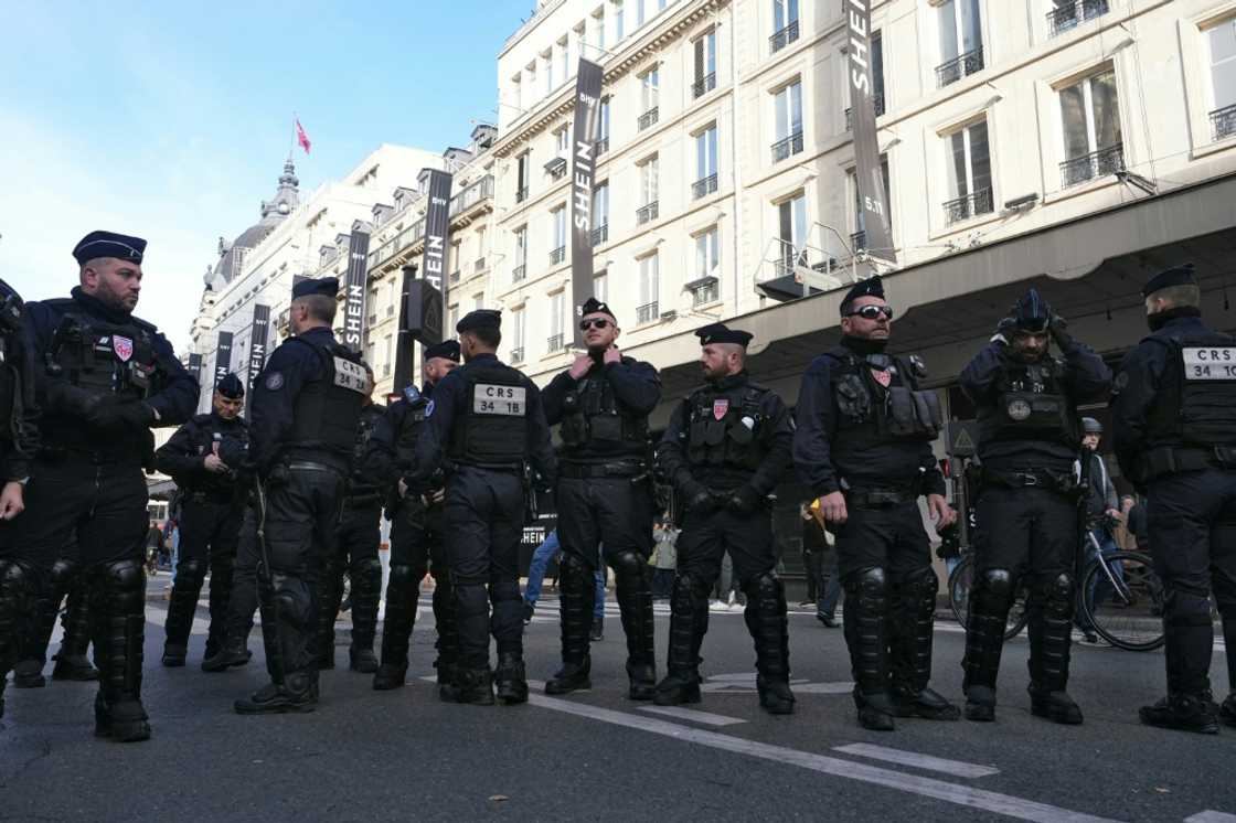 French riot police officers stand guard in central Paris on the opening day of Asian e-commerce giant Shein's first physical store in the world