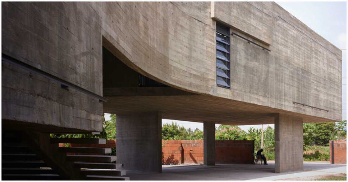 A man sits under the art gallery