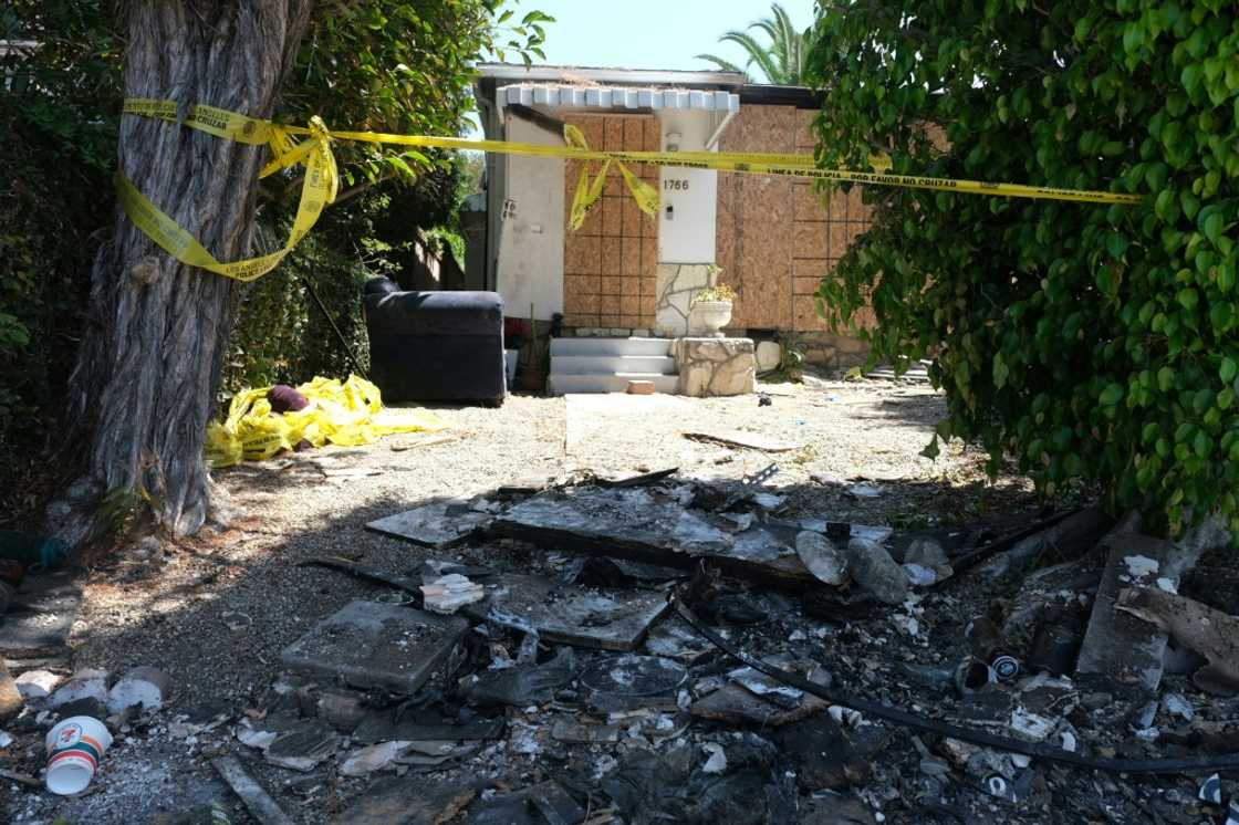 Charred debris and caution tape are seen at the home where US actress Anne Heche crashed her car last week Charred debris and caution tape are seen at the home where US actress Anne Heche crashed her car last week