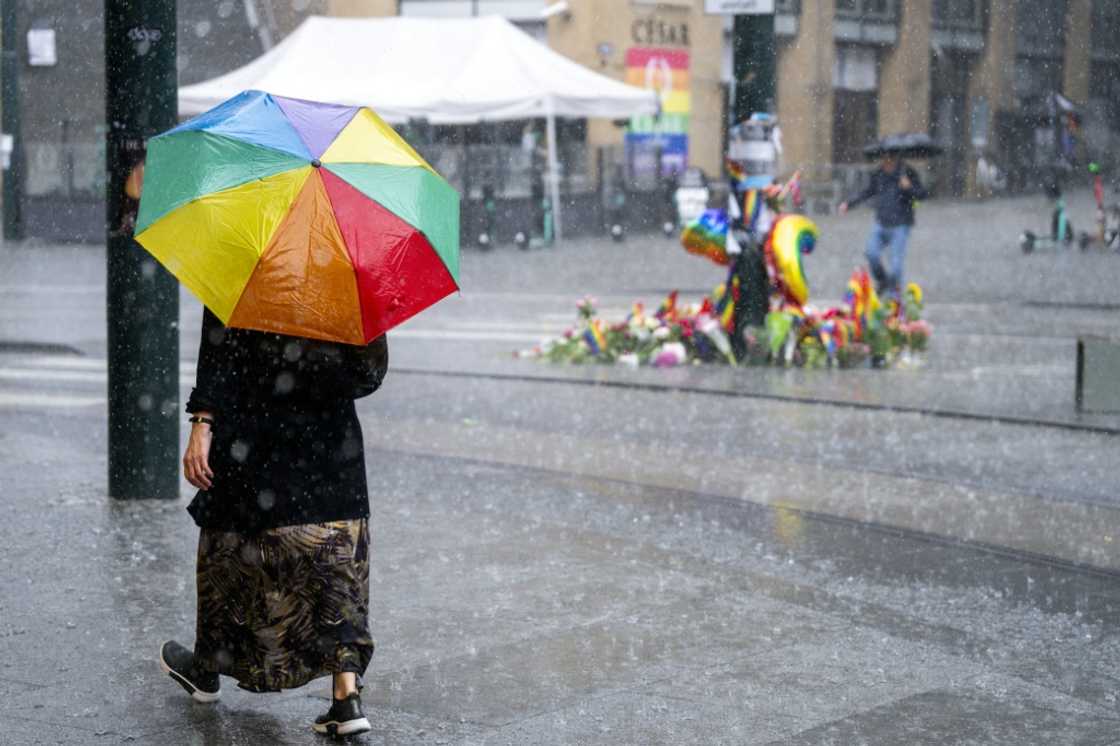 A woman walks past the memorial at the site in Oslo, Norway where two people where shot in an attack against several gay bars A woman walks past the memorial at the site in Oslo, Norway where two people where shot in an attack against several gay bars