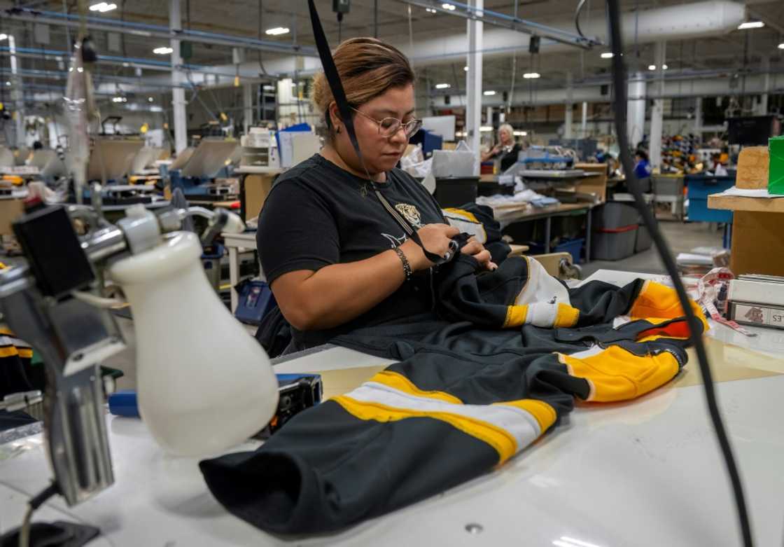 An employee works on a jersey at SP Apparel in Saint-Hyacinthe, Quebec; the Canadian firm makes jerseys for all 32 NHL teams