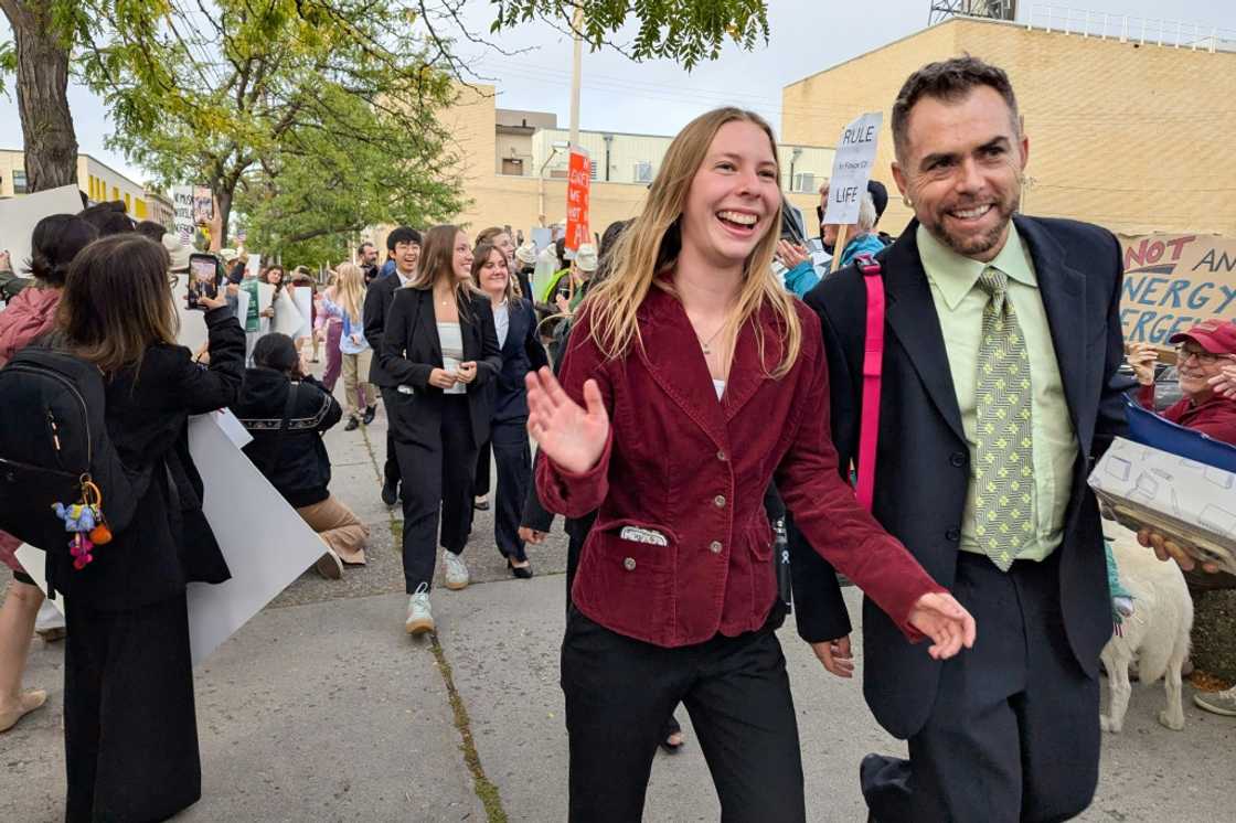 Eva Lighthiser (2R), lead plaintiff in the Lighthiser v. Trump case, walks with attorney Mat dos Santos as they arrive at the Russell Smith Courthouse in Missoula, Montana, on September 16, 2025 Eva Lighthiser (2R), lead plaintiff in the Lighthiser v. Trump case, walks with attorney Mat dos Santos as they arrive at the Russell Smith Courthouse in Missoula, Montana, on September 16, 2025