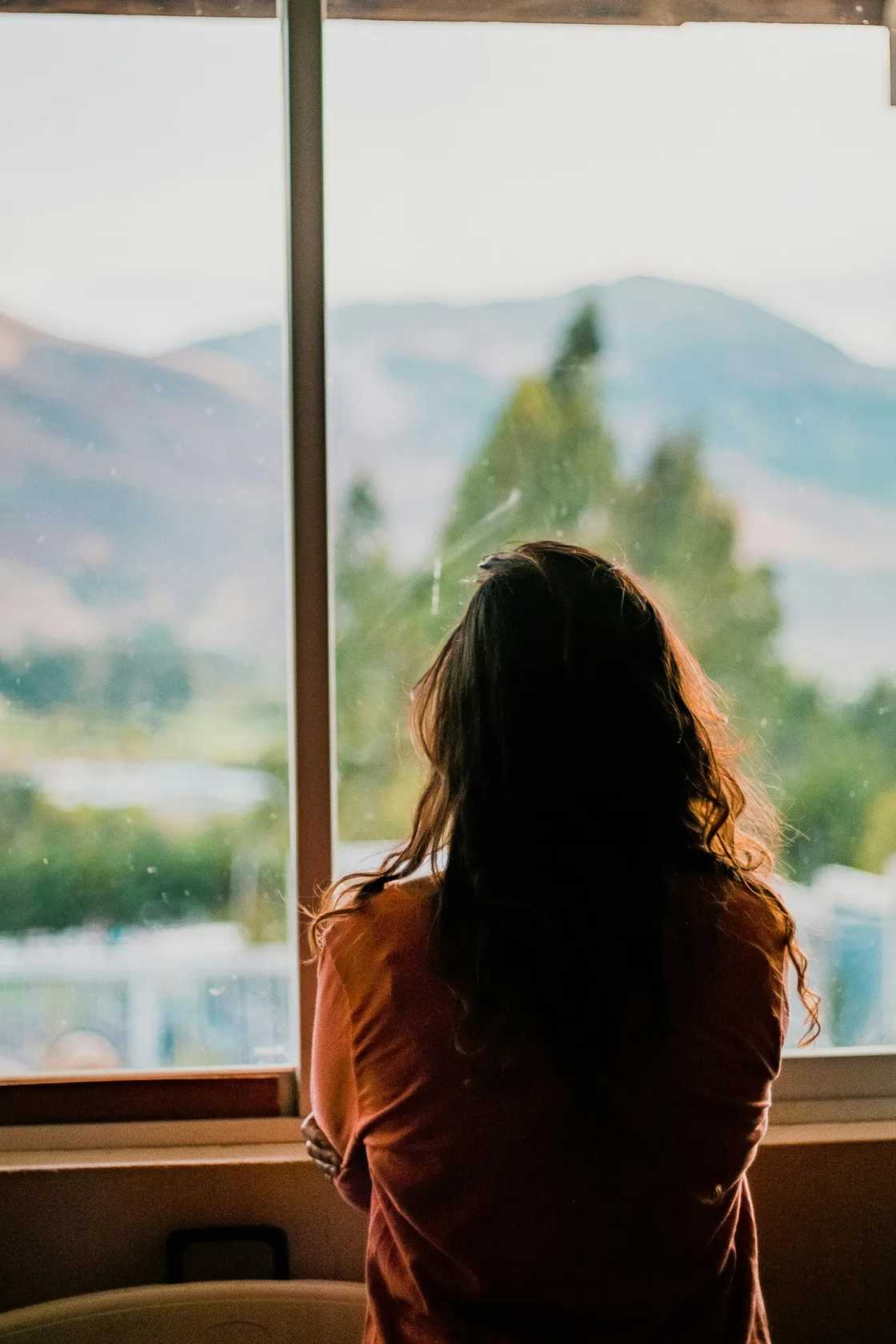 A woman sitting near the window