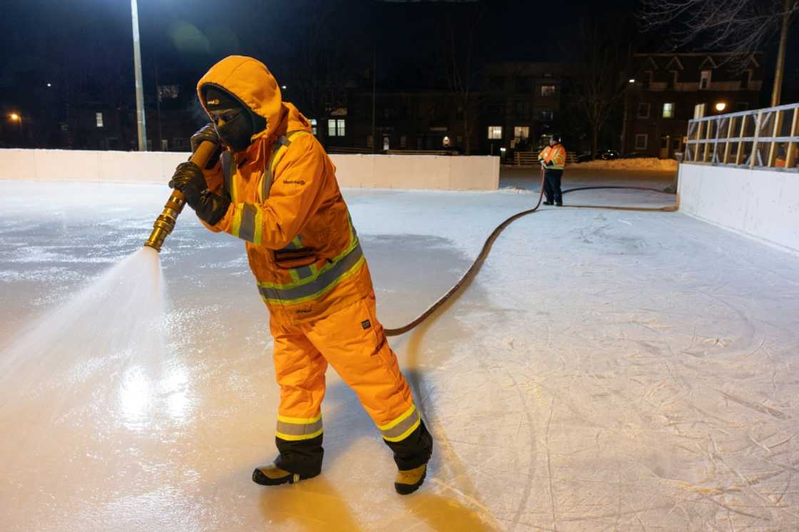 A worker sprays water at the Hibernia Square ice rink in Montreal to thicken fresh ice A worker sprays water at the Hibernia Square ice rink in Montreal to thicken fresh ice