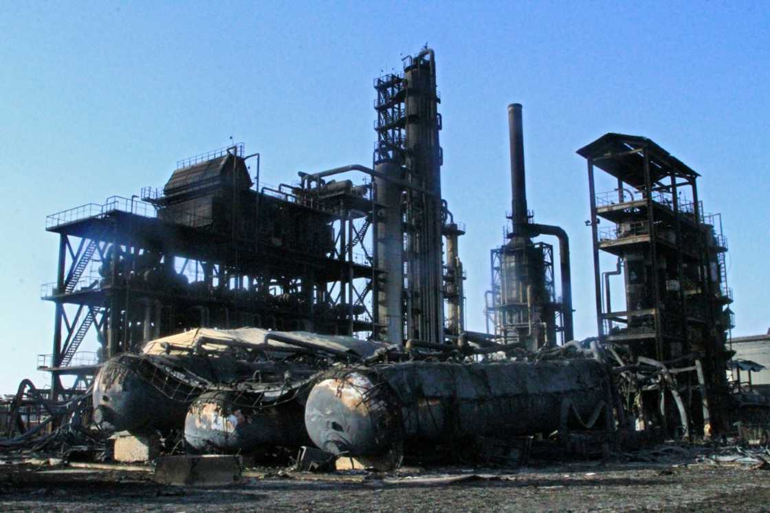 The distillation tanks of Sudan's biggest oil refinery lie blackened on the ground after it became a battleground in the devastating war between the country's rival generals. The distillation tanks of Sudan's biggest oil refinery lie blackened on the ground after it became a battleground in the devastating war between the country's rival generals.