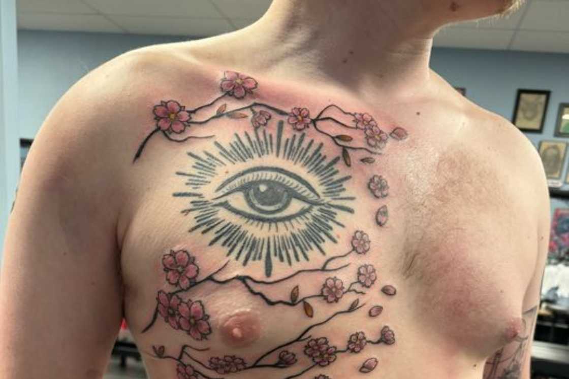 Cherry blossom tattoo with an eye chest tattoo Cherry blossom tattoo with an eye chest tattoo