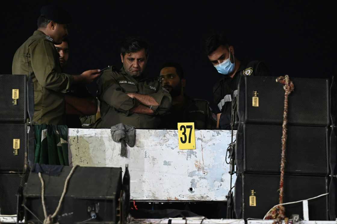 Investigators examine the rooftop of the container truck where Imran Khan was shot Investigators examine the rooftop of the container truck where Imran Khan was shot