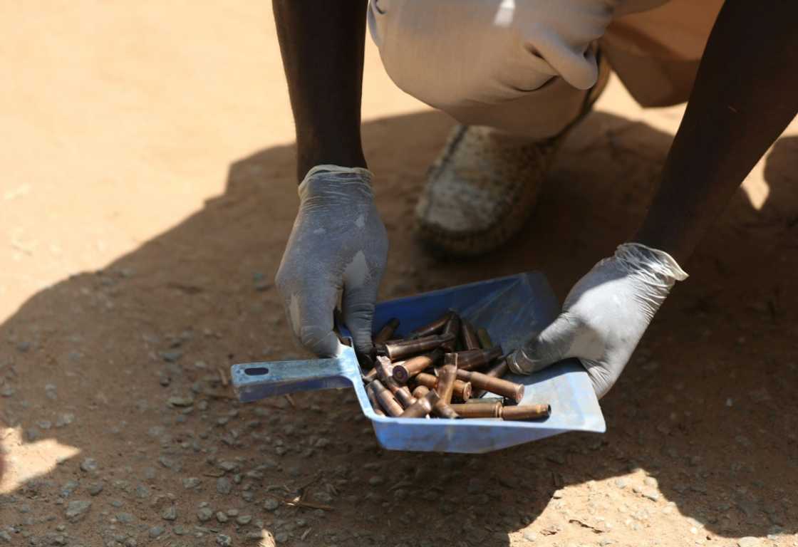 A forensic investigator gathered cartridges fired by the gunmen