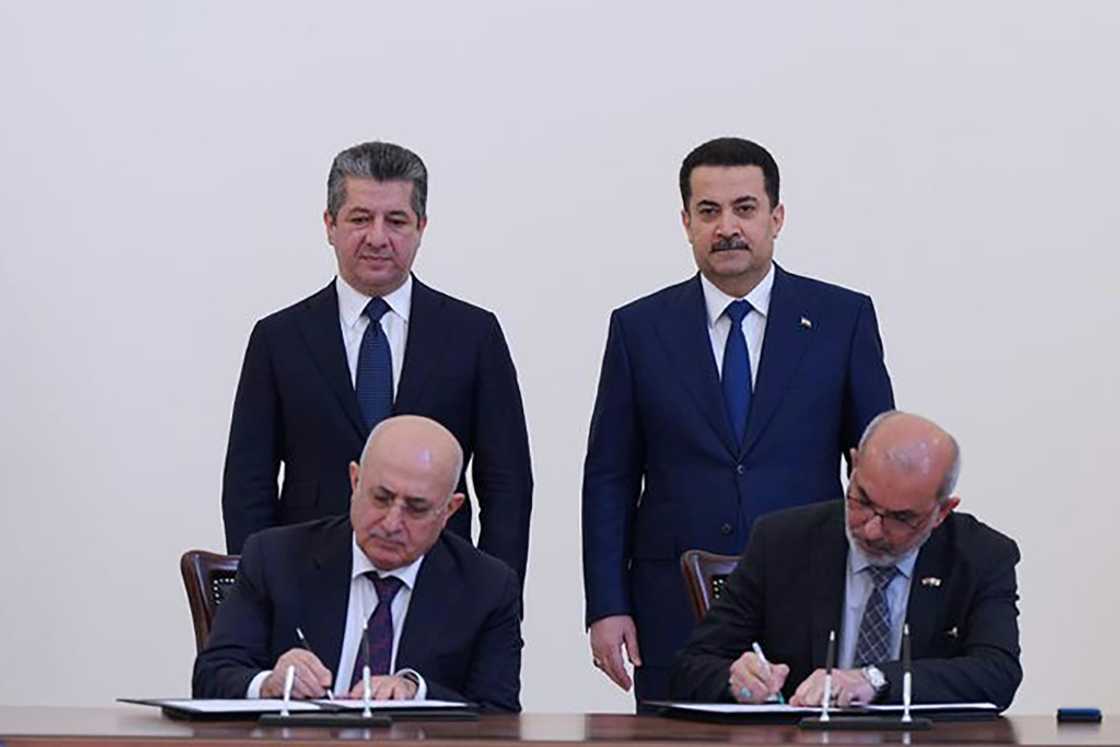 Iraqi Prime Minister Mohammed Shia al-Sudani, standing on the right, and his Kurdish counterpart Masrour Barzani attend the signing of the agreement Iraqi Prime Minister Mohammed Shia al-Sudani, standing on the right, and his Kurdish counterpart Masrour Barzani attend the signing of the agreement
