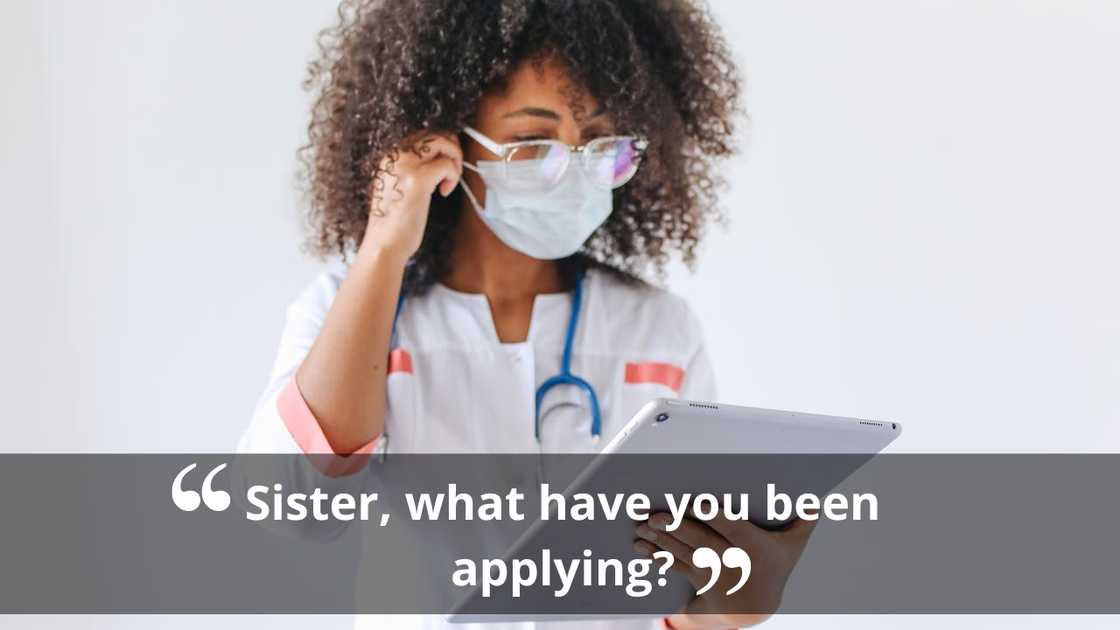 A healthcare worker wearing a mask and reading from a tablet. A healthcare worker wearing a mask and reading from a tablet.