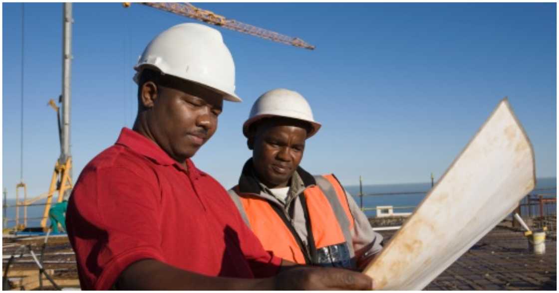 Two men working at a construction site