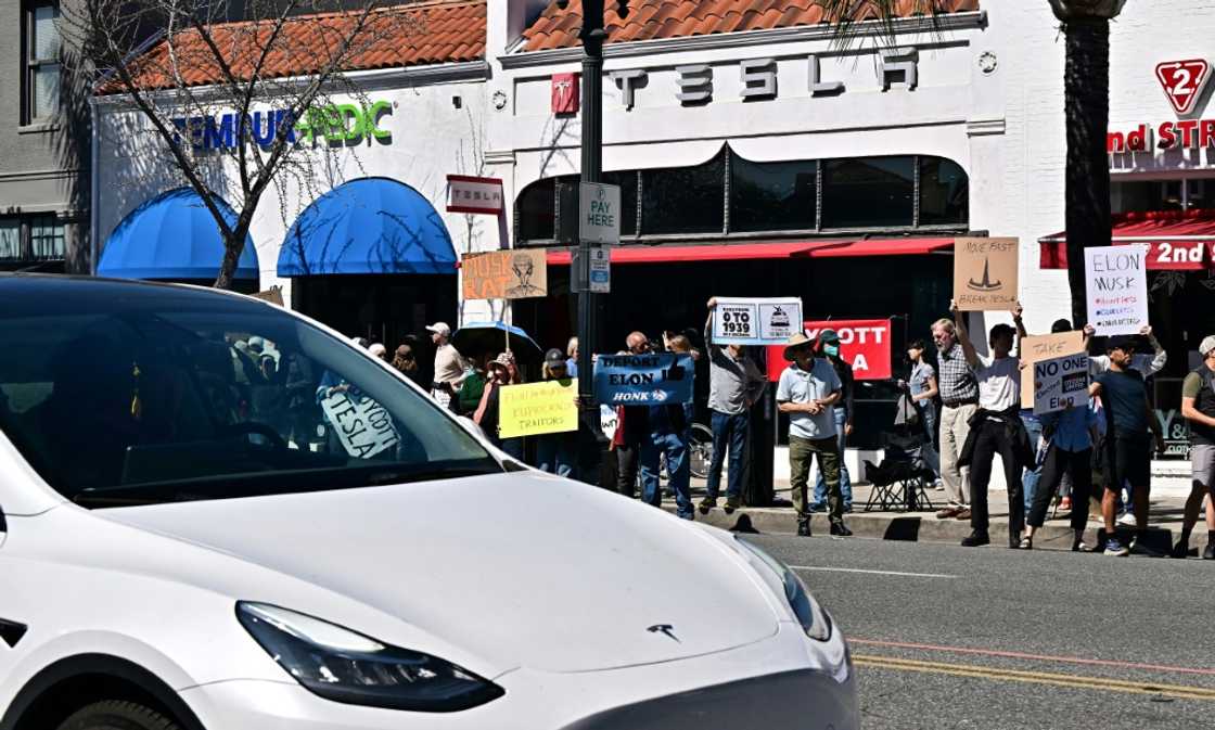 People participate in a protest against Elon Musk outside a Tesla dealership in Pasadena, California on March 8, 2025 People participate in a protest against Elon Musk outside a Tesla dealership in Pasadena, California on March 8, 2025