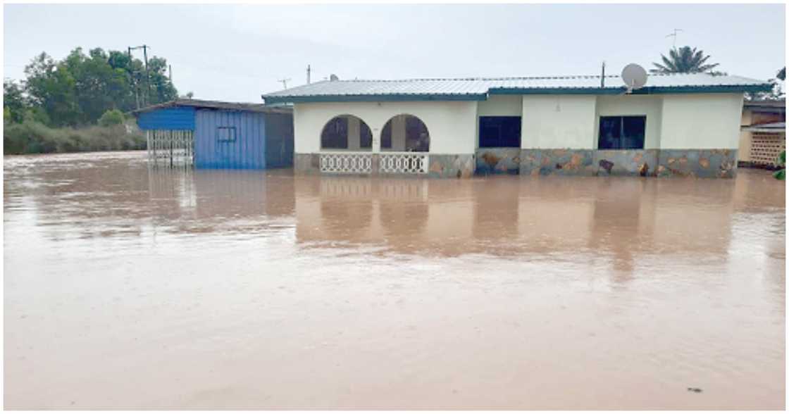 A house with a flooded compound