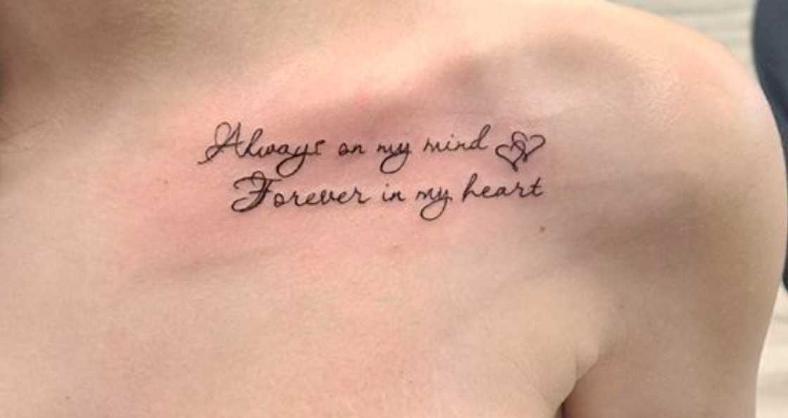 Through the dark lettering, the collarbone tattoo