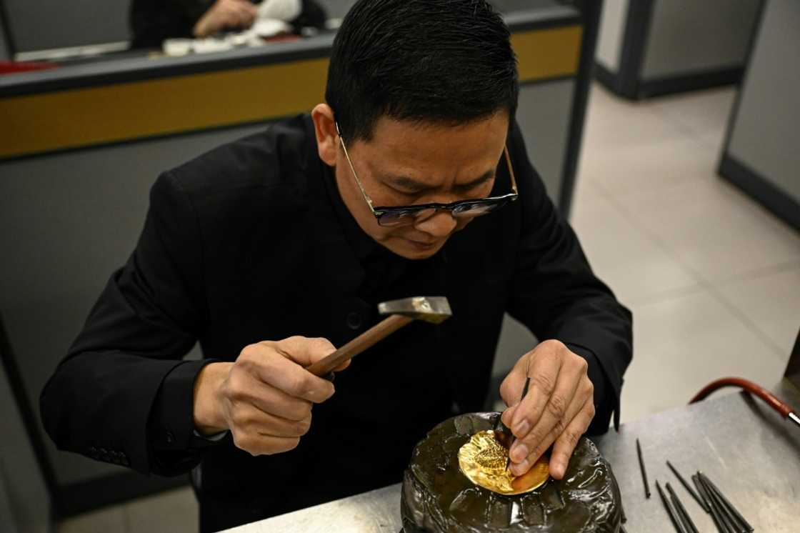 A jewellery craftsman works on a gold piece at the Chow Tai Fook master studio in Foshan, in southern China's Guangdong province A jewellery craftsman works on a gold piece at the Chow Tai Fook master studio in Foshan, in southern China's Guangdong province