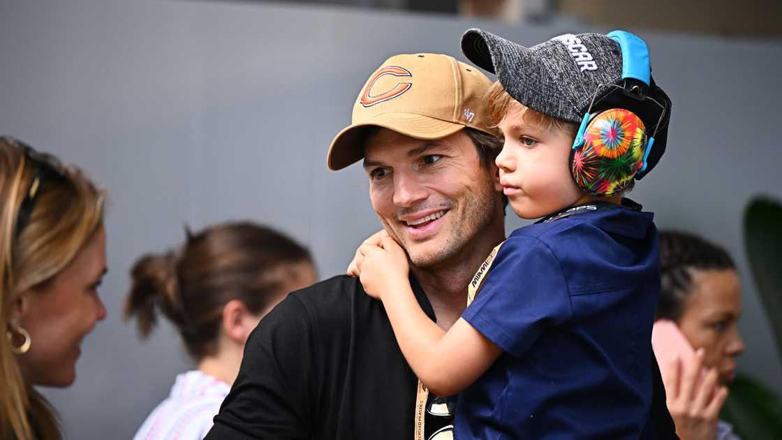 Ashton Kutcher carries his son Dimitri Portwood