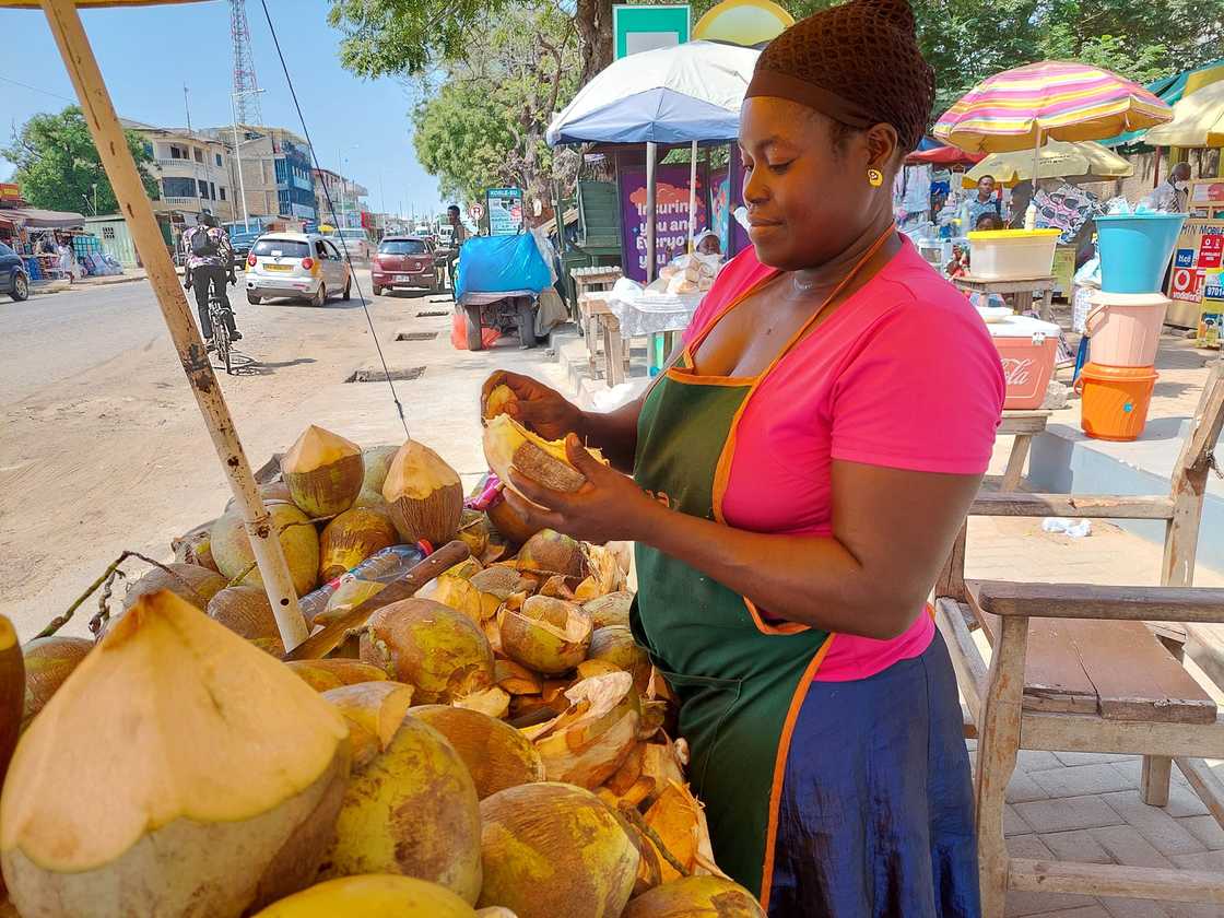 Ghanaian female coconut vendor. Ghanaian female coconut vendor.