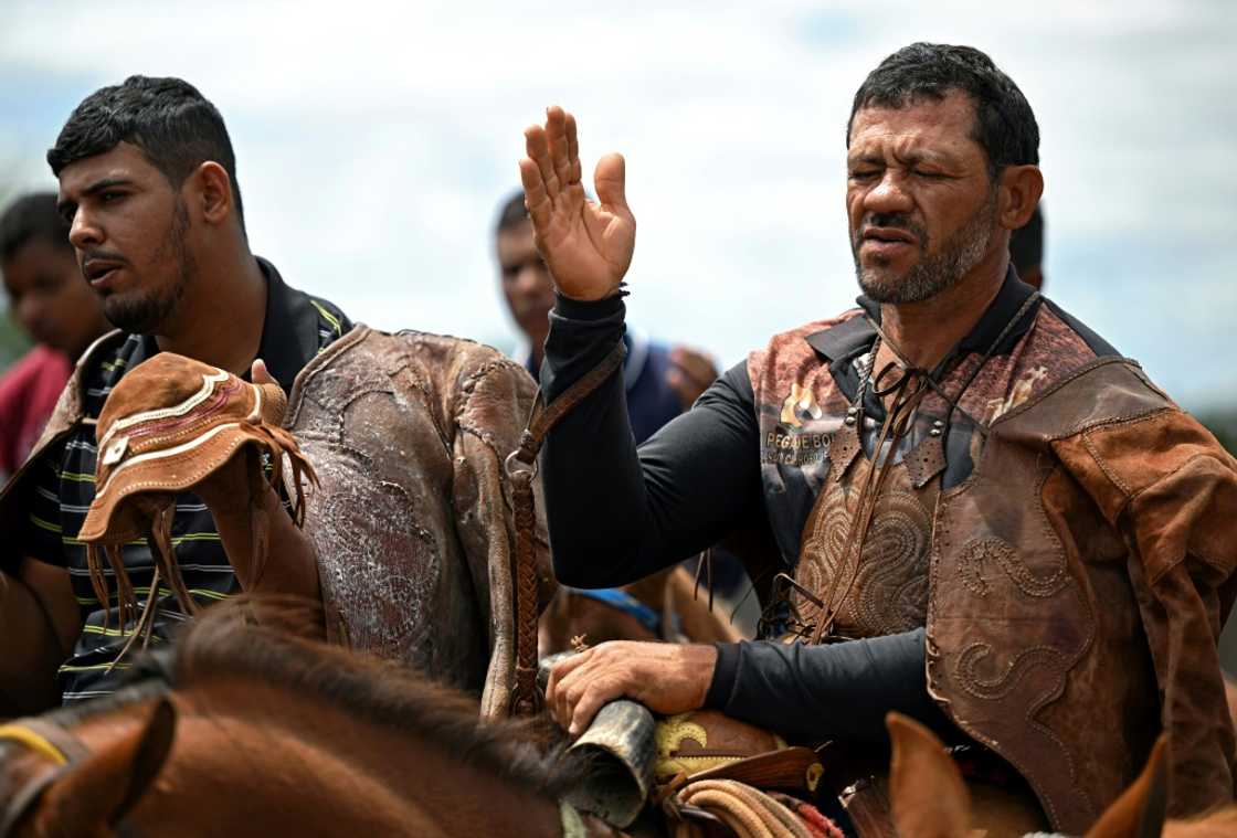 Riders take part in a Catholic mass on horseback before competing Riders take part in a Catholic mass on horseback before competing