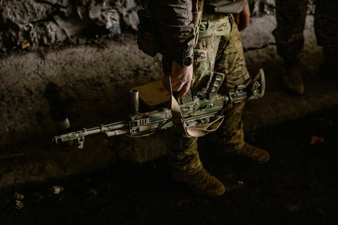 A Ukrainian soldier holds his assault rifle in the town of Bakhmut on October 23, 2022 A Ukrainian soldier holds his assault rifle in the town of Bakhmut on October 23, 2022
