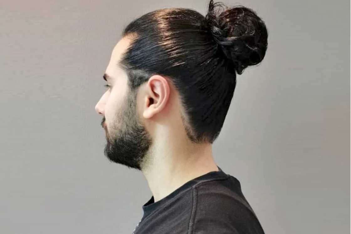 A man rocks a high man bun A man rocks a high man bun