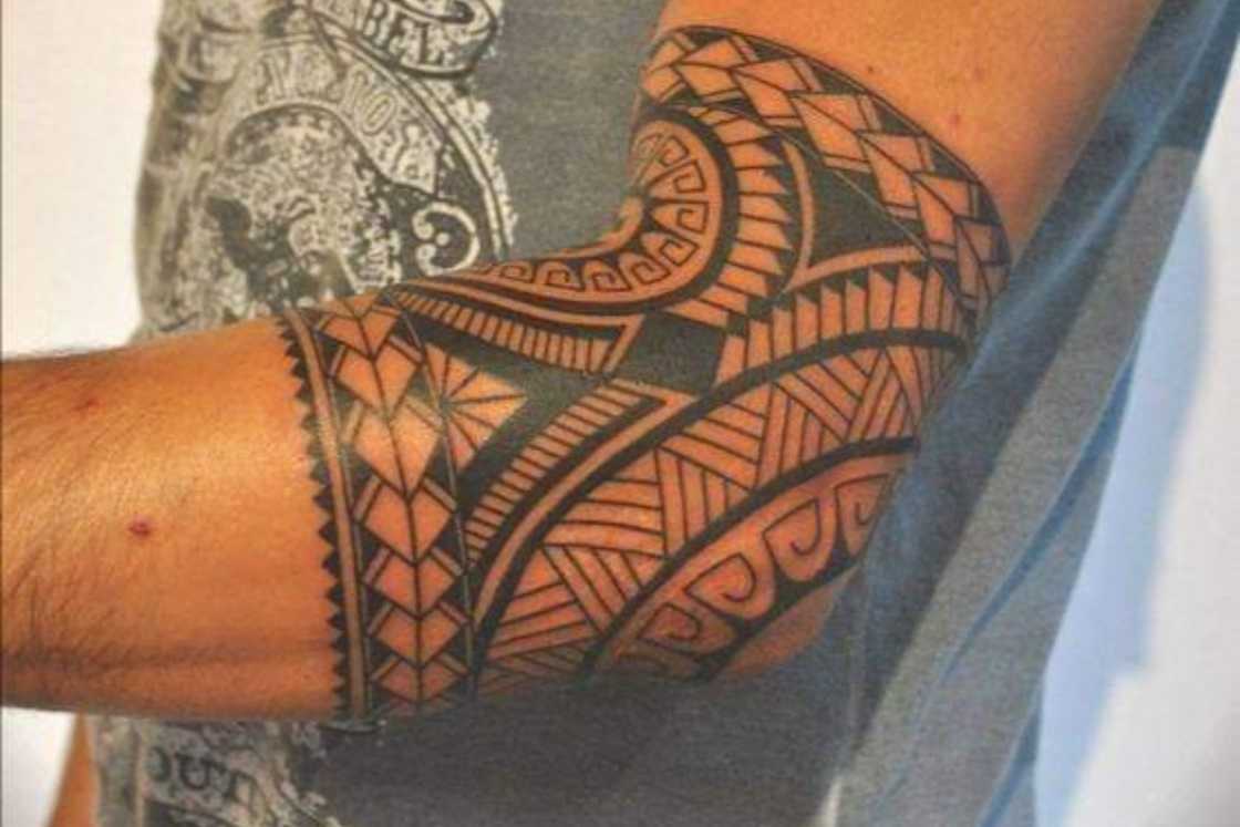 A tribal elbow tattoo tattoo wrapping around the joint A tribal elbow tattoo tattoo wrapping around the joint