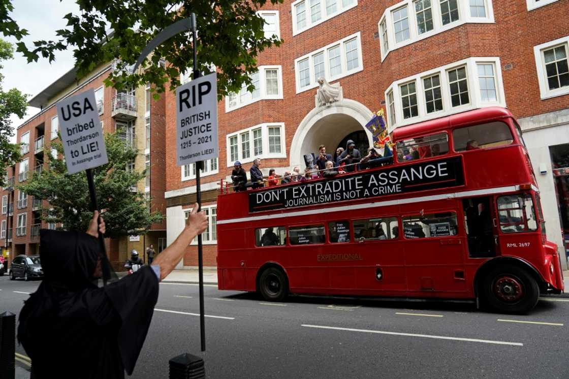 Protesters aboard a double-decker bus protested outside Britain's interior ministry against Assange's extradition Protesters aboard a double-decker bus protested outside Britain's interior ministry against Assange's extradition