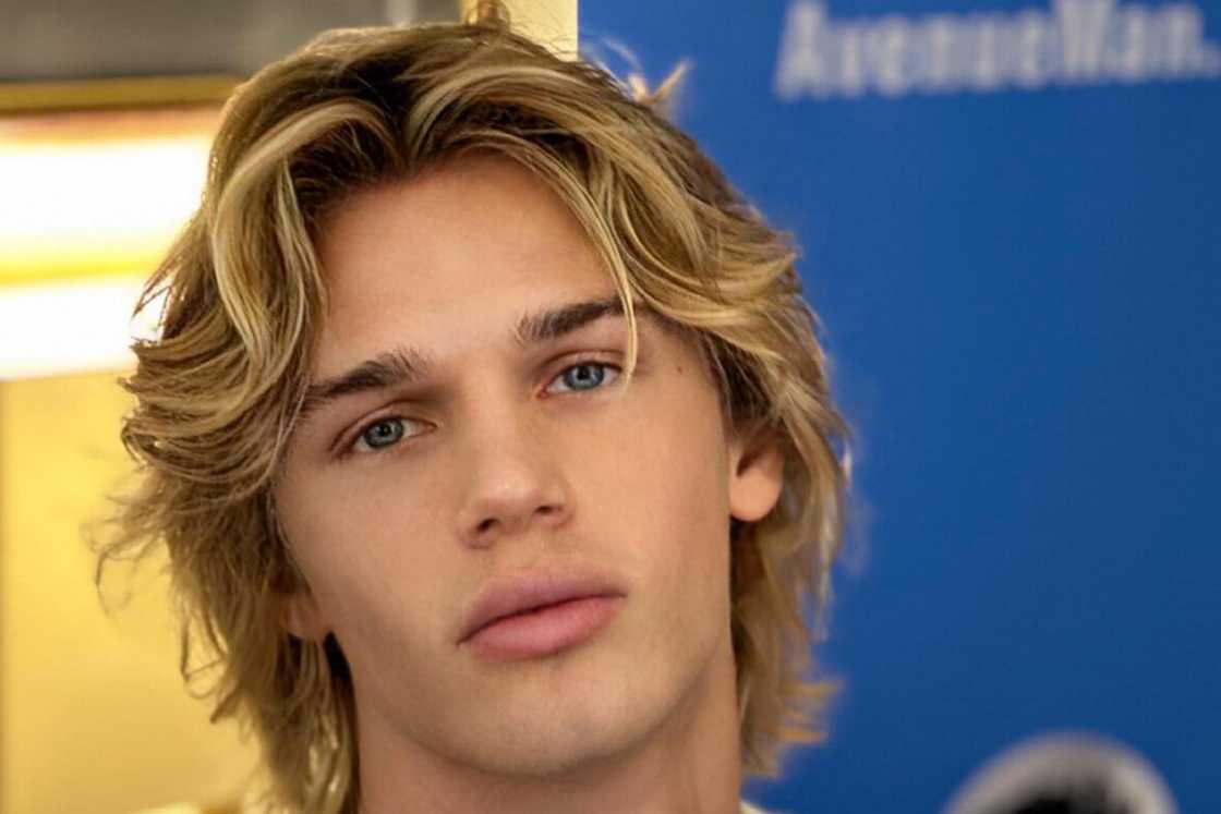 A young man is rocking a bro flow hairstyle A young man is rocking a bro flow hairstyle