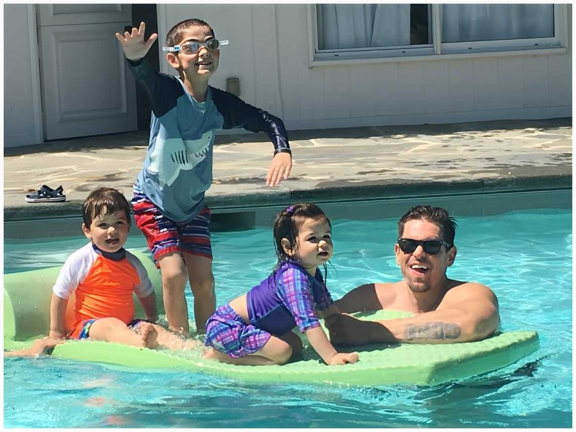 Knox Blue (L), William Wolf (C), Violet (R), and their dad in the water Knox Blue (L), William Wolf (C), Violet (R), and their dad in the water