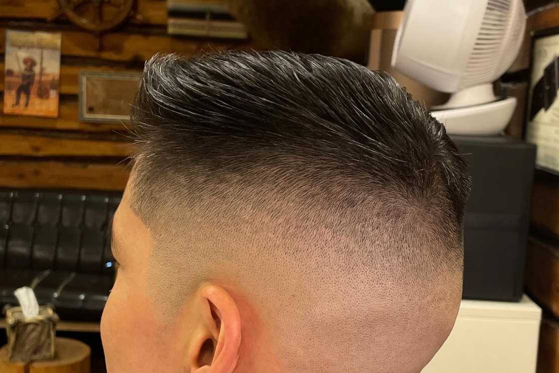 A white man with a crew cut hairstyle is inside a room A white man with a crew cut hairstyle is inside a room